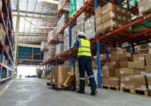 A warehouse worker is seen. Dimensional Weighing offers DEM scales in Peoria IL.