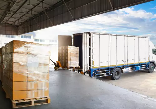 Trucks are seen at a loading dock. Dimensional Weighing offers dimensional scales in Peoria IL for accurate weighting and measurements.