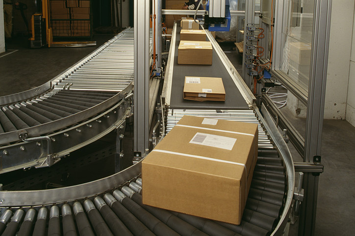 An operational in-motion dimensional scanner scanning packages as they pass through the conveyor belt system