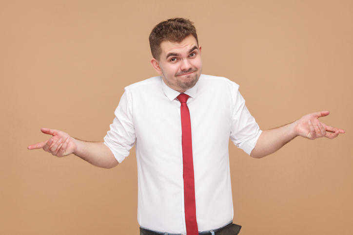 A man shrugging, not sure which dimensional weighing system to use for his facility